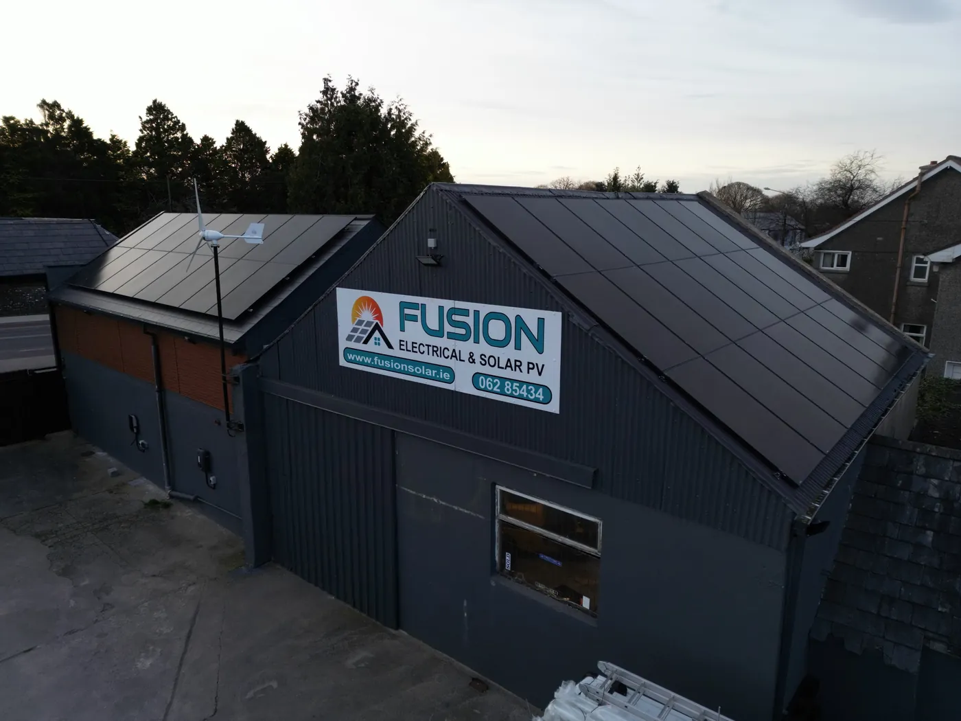 Fusion Solar's yard in Cashel with solar panels on the roof